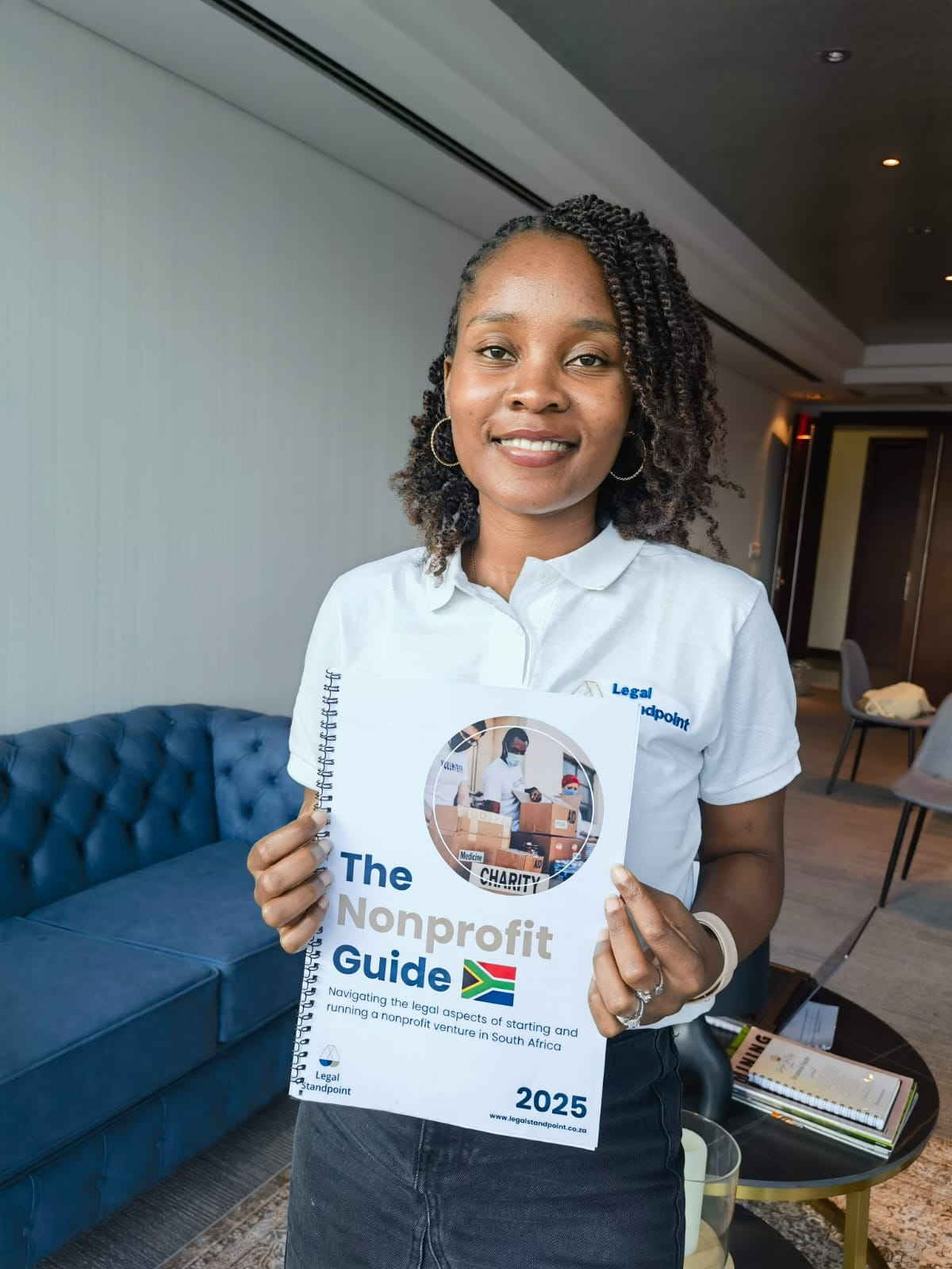 Team member holding The Nonprofit Guide 2025