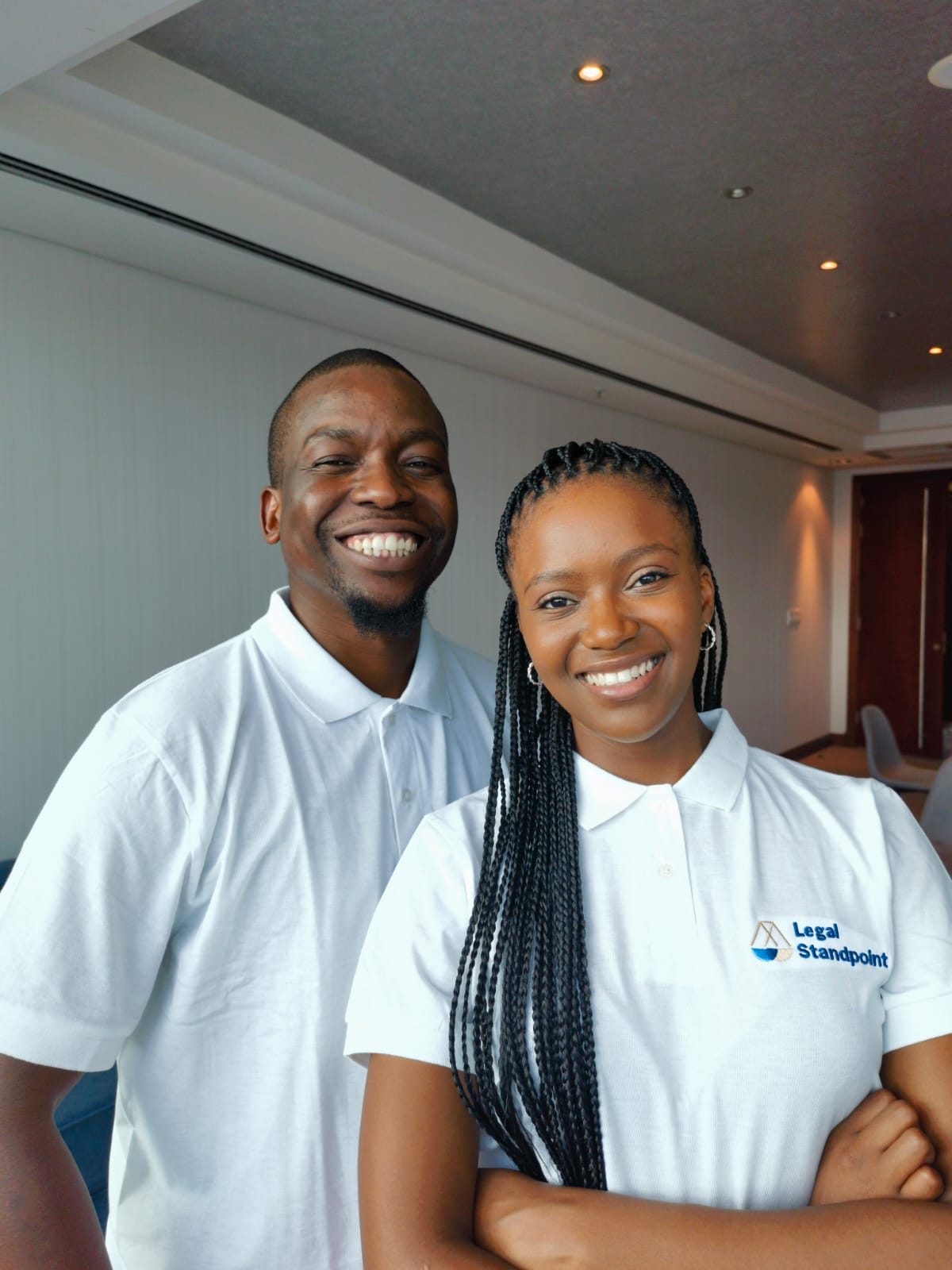 Two Legal Standpoint team members in branded shirts